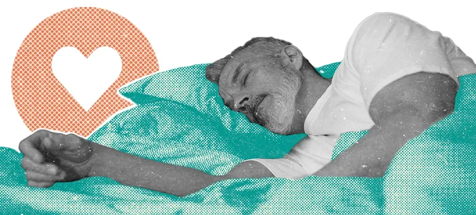 A man sleeping iwth a heart symbol above his pillows