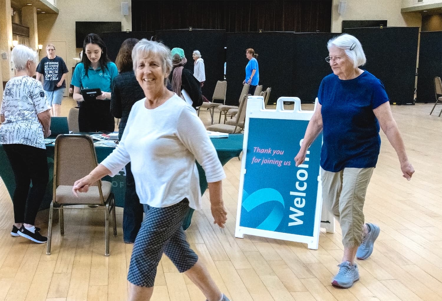 two elderly women walking through medical clinic
