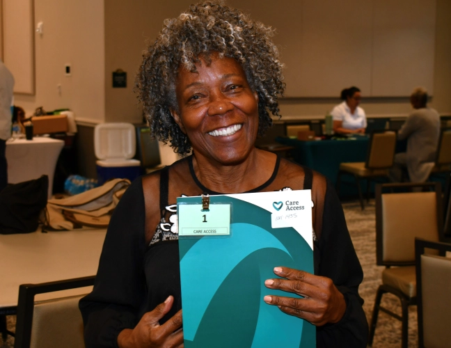 Woman smiling holding folder