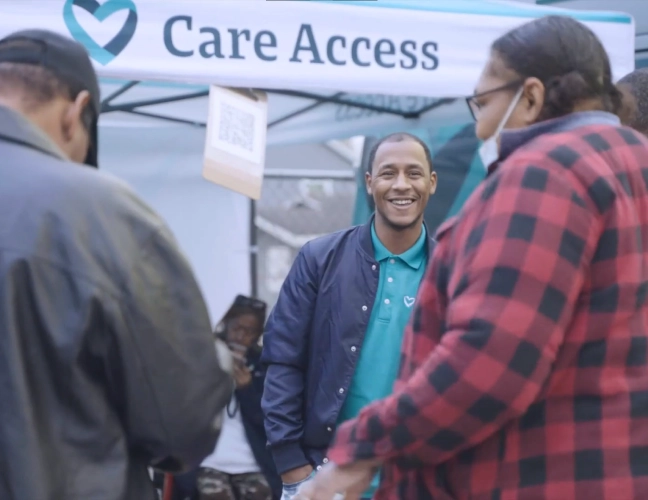 Man smiling under Care Access logo