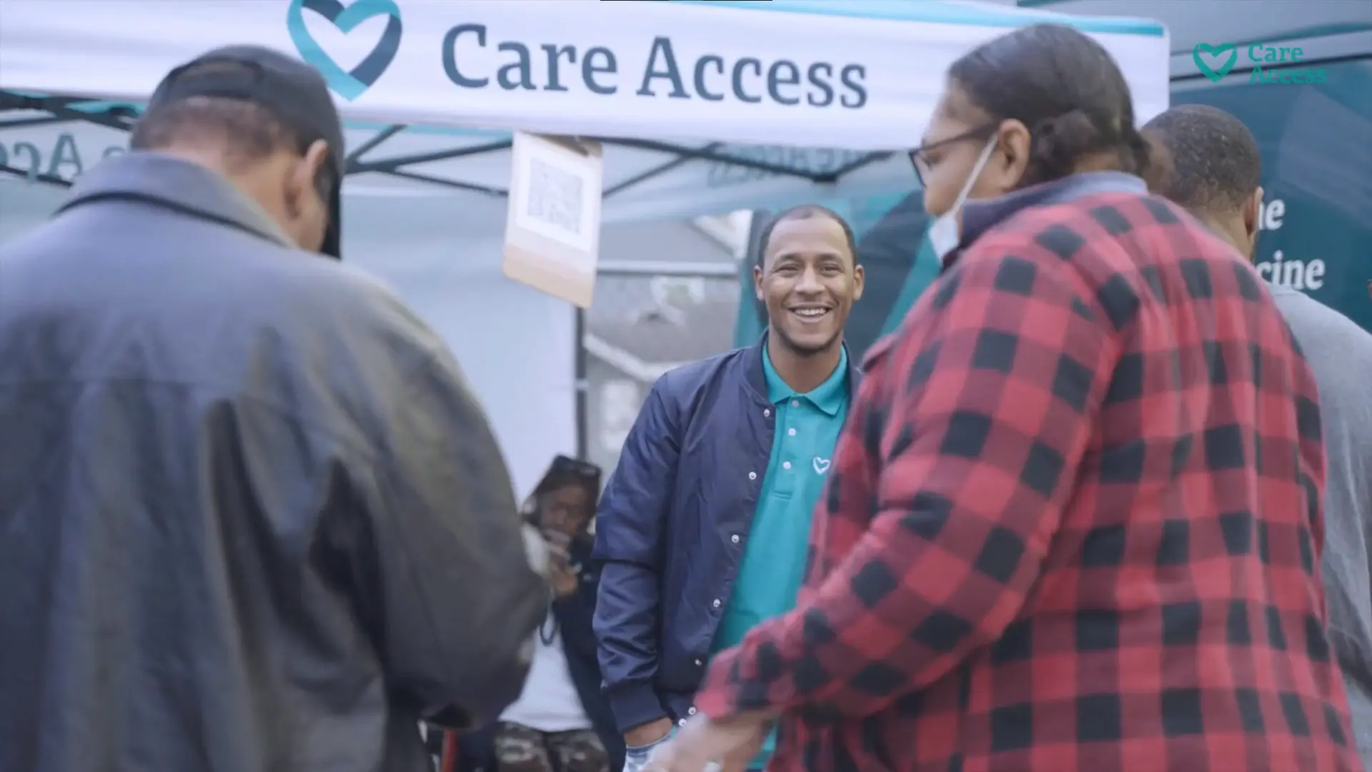 man smiling infront of CareAccess logo