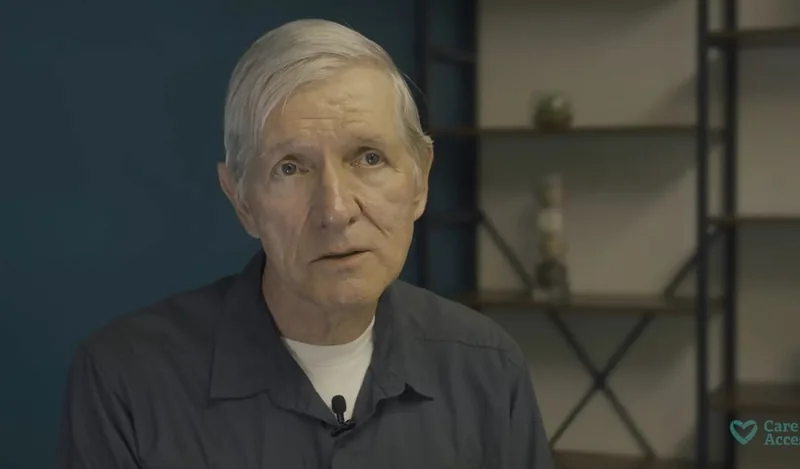 Charles seated indoors during an interview