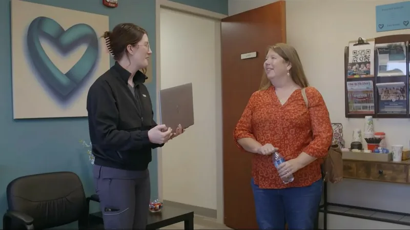 Shelby talking with a Care Access team member in a clinic room